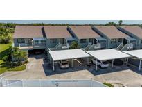 Close aerial of condo units featuring carports and balconies on each unit and well-kept exterior at 1408 San Cristobal Ave # 4, Punta Gorda, FL 33983