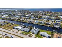 Waterfront property with backyard canal access and a beautiful neighborhood view on a sunny day at 21269 Edgewater Dr, Port Charlotte, FL 33952