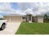 Beautiful single-story home with a three-car garage and well-manicured lawn, perfect for families or retirees at 9529 Calumet Blvd, Port Charlotte, FL 33981