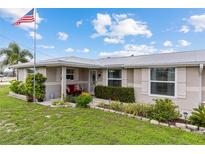 Close-up of charming home showcasing front porch with plants and a cozy seating area at 21194 Edgewater Dr, Port Charlotte, FL 33952