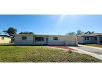 Charming single-story home featuring a well-maintained front lawn and an attached garage at 3372 Elkcam Blvd, Port Charlotte, FL 33952