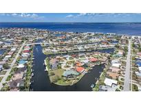 Stunning aerial view of waterfront homes with canals, docks, and ocean access, showcasing coastal living at 1791 Belle Ct, Punta Gorda, FL 33950