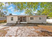 Single-story home featuring a screened-in entryway and neutral paint, awaiting a personal touch at 102 21St Ne St, Bradenton, FL 34208