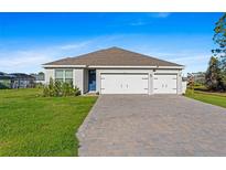 Charming single-story home featuring a spacious three-car garage and well-manicured lawn at 25336 Deep Creek Blvd, Punta Gorda, FL 33983