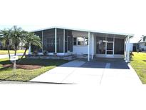 Well-maintained single-story home featuring a screened-in porch, covered parking, and a beautifully landscaped yard at 715 Fairmount Dr, North Port, FL 34287