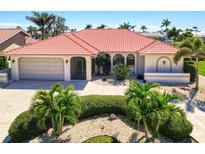 Inviting single story home with a Spanish tile roof, beautiful landscaping, and a two car garage at 815 Via Formia, Punta Gorda, FL 33950