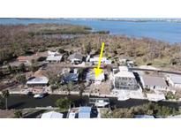 This aerial view showcases the waterfront home with canal access and lush surrounding vegetation at 2061 S Pine St, Englewood, FL 34224