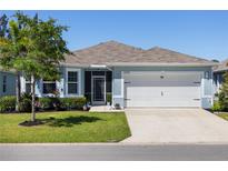 Charming single-story home with a two-car garage and well-manicured lawn and garden at 25292 E Lenox Cir, Punta Gorda, FL 33950
