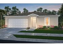 Charming one-story home with a two-car garage, neutral color palette, and well-maintained landscaping at 5517 Fairlane Dr, North Port, FL 34288