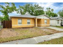 Charming single-story home featuring a stucco exterior, a concrete driveway, and a well-maintained yard at 8706 Fish Lake Rd, Tampa, FL 33619
