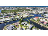 Beautiful aerial view of a waterfront home with private dock and direct access to the open water at 955 Don Juan Ct, Punta Gorda, FL 33950