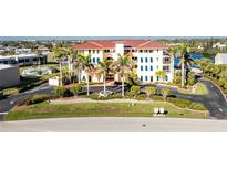 Beautiful low angle daytime exterior view of the condo with palm trees and well maintained landscaping at 1340 Rock Dove Ct # 132, Punta Gorda, FL 33950