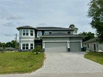 Stunning two-story home with a three-car garage and beautifully paved driveway at 22223 Seyburn Ter, Port Charlotte, FL 33954