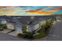 Beautifully landscaped single-Gathering home exterior with a two-car garage and well-maintained lawn at sunset at 1751 Nottingham Trl, Punta Gorda, FL 33980