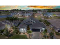 Stunning front elevation showing the lush landscaping and well-manicured lawn in this lovely gated community at 24260 Westgate Blvd, Port Charlotte, FL 33980