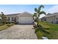 Charming one-story home featuring a spacious two-car garage and a beautifully paved driveway at 1796 W Palms Dr, Port Charlotte, FL 33953