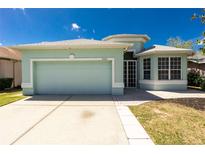 Charming single-story home featuring a well-manicured lawn and attached garage at 2241 Boxwood St, North Port, FL 34289