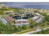 Serene community featuring condos with water views, lush landscaping, two ponds with water features, and community amenities at 23465 Harborview Rd # 915, Punta Gorda, FL 33980