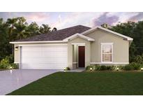 Charming one-story home featuring a two-car garage, manicured lawn, and welcoming facade at 245 Granada Blvd, North Port, FL 34287