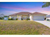 Charming single-story home featuring an attached two-car garage and well-maintained front lawn at 3935 Nemo Ave, North Port, FL 34287