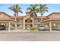 Inviting condo building with palm trees and covered parking spaces, perfect for coastal living at 7196 N Plum Tree # 323, Punta Gorda, FL 33955