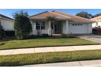 Charming single-story home with a well-manicured lawn and attached two-car garage in a sunny neighborhood at 6379 Grand Cypress Blvd, North Port, FL 34287