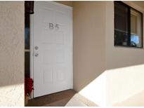 A front door with a light shining on it and the unit number B5 at 1211 Saxony Cir # B5, Punta Gorda, FL 33983