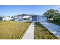 Charming single-story home featuring a well-maintained lawn and neutral paint at 22220 Lasalle Rd, Port Charlotte, FL 33952