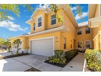 Charming two-story home with a well-maintained lawn, a two-car garage, and beautiful landscaping at 25559 Heritage Lake Blvd # 25, Punta Gorda, FL 33983