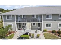 Two-story condo building featuring well-maintained landscaping and convenient access to each unit at 3310 Loveland Blvd # 1102, Punta Gorda, FL 33980