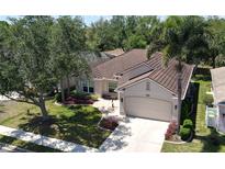Stunning single Gathering home with a well-manicured lawn, tile roof, and attached two car garage at 2836 Suncoast Lakes Blvd, Punta Gorda, FL 33980
