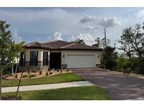 Beautiful single-story home with a well-manicured lawn and paver driveway at 1263 Cicely Ct, North Port, FL 34289