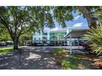 Condominium with assigned covered parking and tropical landscaping at 19385 Water Oak Dr # 302, Port Charlotte, FL 33948