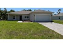 Charming single-story home with a well-maintained lawn and a two-car garage at 20241 Lorette Ave, Port Charlotte, FL 33954