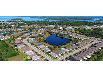 Beautiful aerial view of the community with a lake and well-maintained homes near the water and green spaces at 28059 Arrowhead Cir, Punta Gorda, FL 33982