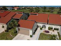 Attractive single-Gathering home with a striking terracotta roof, well-maintained landscaping, and an attached garage at 5061 San Rocco Ct, Punta Gorda, FL 33950