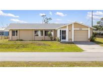 Charming single-story home with a well-maintained lawn and attached garage, perfect for suburban living at 558 Azalea Drive, Port Charlotte, FL 33952