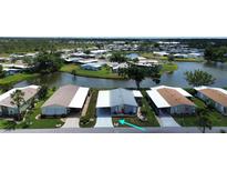 A waterfront home with lush landscaping and community lake views in a peaceful 55+ neighborhood at 749 Watersedge St, Englewood, FL 34223