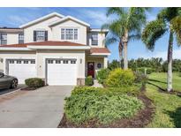 Inviting two-story home with well-manicured landscaping and attached two-car garage at 1085 Jonah Dr, North Port, FL 34289