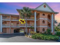 Inviting condo exterior featuring well-maintained landscaping and a glimpse of the private balcony at 1326 Wesley Dr # 123, Punta Gorda, FL 33950