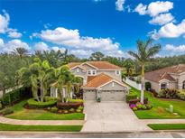 Beautiful home with a three-car garage, beautiful landscaping, and a tile roof at 1814 Pinyon Pine Dr, Sarasota, FL 34240