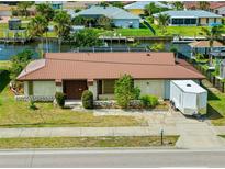Charming single-story home featuring a canal front location and attractive landscaping at 21169 Edgewater Dr, Port Charlotte, FL 33952