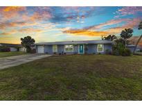 Charming one-story home with well-maintained lawn, lush landscaping, and updated exterior paint at 2236 Arnet St, Port Charlotte, FL 33948