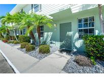 Inviting condo entrance featuring lush landscaping and a well-maintained walkway leading to a painted front door at 26396 Nadir Rd # 507, Punta Gorda, FL 33983