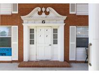 Close-up of the building's main entrance, featuring a decorated doorway and clear unit numbers at 4158 Tamiami Trl # G1, Port Charlotte, FL 33952