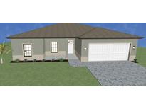 Charming single-story home featuring a two-car garage and well-manicured lawn at 4425 Lagoon Ter, North Port, FL 34286