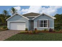 Charming single-story home with a two-car garage, manicured lawn, and beautiful landscaping at 15264 Buswell Ave, Port Charlotte, FL 33953