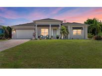 Charming single-story home with a well-maintained lawn and inviting front porch at 2636 Mauritania Rd, Punta Gorda, FL 33983