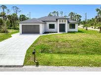Charming single-story home with a well-manicured lawn and attached two-car garage at 3140 Lopinto St # 1, North Port, FL 34287
