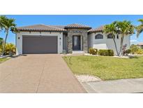 Charming single-Gathering home features a tile roof, an attached garage, and a well-manicured lawn at 4001 La Costa Island Ct, Punta Gorda, FL 33950